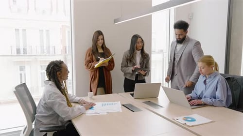 A Diverse Group of Individuals Collaborating in a Modern Office Setting for Success