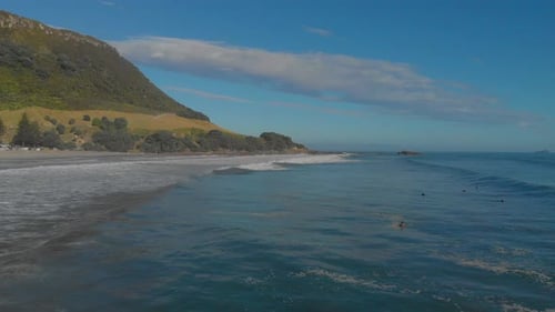 AERIAL: Surfers at Mount Maunganui Beach, New Zealand. 3