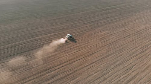 Drone View of Farming Tractor Plowed Field Before Seeding Crops