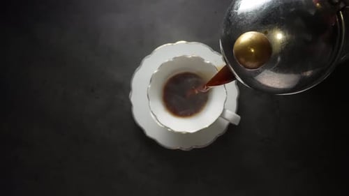 Pouring Coffee Into Delicate White Cup Overhead