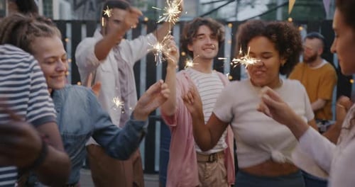 Friends Celebrating Together with Sparklers Outdoors