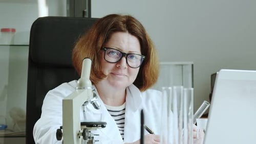 Woman Scientist Working in Lab Smiling