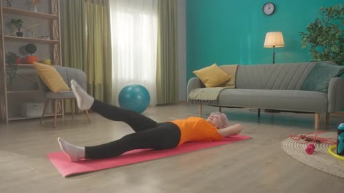 Senior Woman Exercising on Yoga Mat at Home