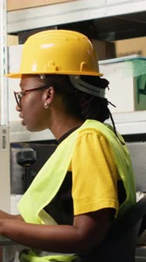 Warehouse Worker Scanning Packages in Distribution Center