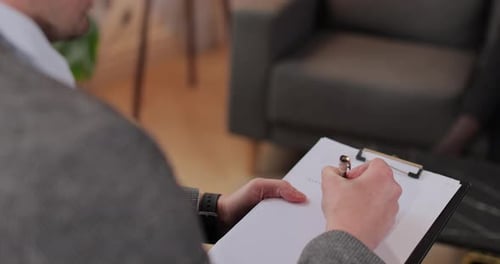 Close Up Man Therapist Taking Notes on Papers at Psychology Session with Unhappy Woman Complaining