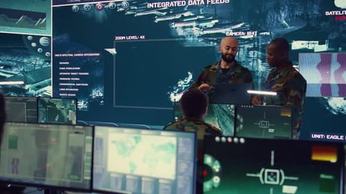 People in Command Center Monitor Satellite Imagery