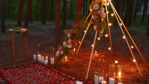 Romantic Teepee Setup with Flowers and Lights in Woods