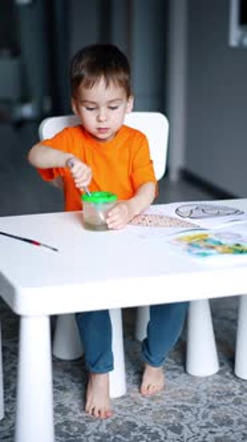 Child Painting at a Small Table Indoors