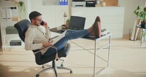 Man Working From Home Talking on Phone