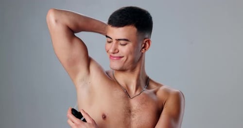 Studio, smile and man with deodorant, armpit and body care with confidence