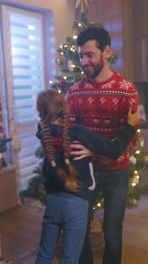 Family Christmas Fun: Father Daughter Dancing by Tree