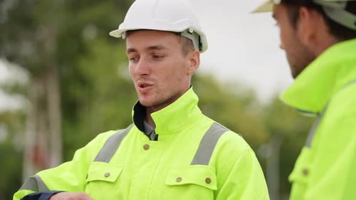 Construction Workers Discussing Project on Site