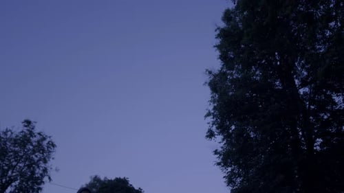 Figure in Hooded Jacket Carrying Black Monitor