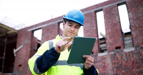 Engineer, man and typing on construction site with tablet, planning and check building safety