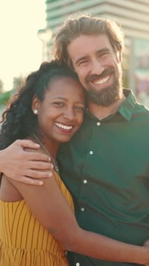 Close-up of happy interracial couple in the port, backlighting