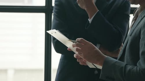 Business People Discussing Documents in Modern Office