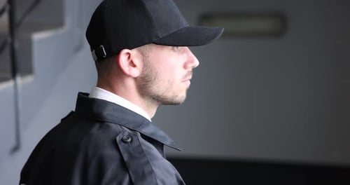 Bodyguard in uniform using walkie talkie indoors