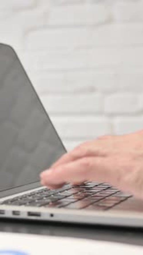 Close Up of Hands Typing on a Laptop