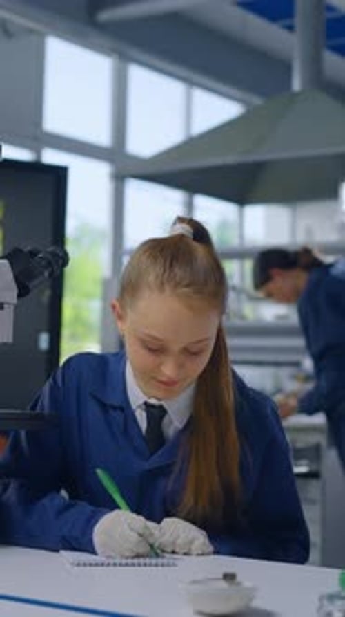 Teenage Scientist Working in Lab Taking Notes