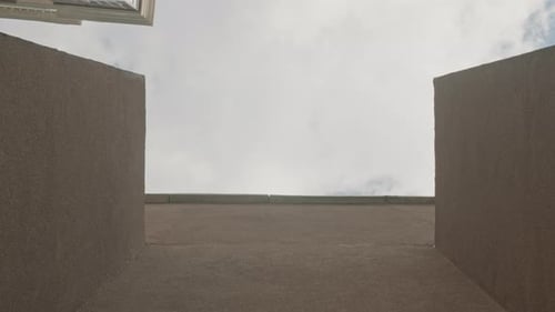 Guy Jumping from Building to Building Bottom View