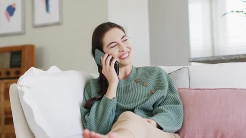 Happy Woman Laughing Talking on Phone Indoors