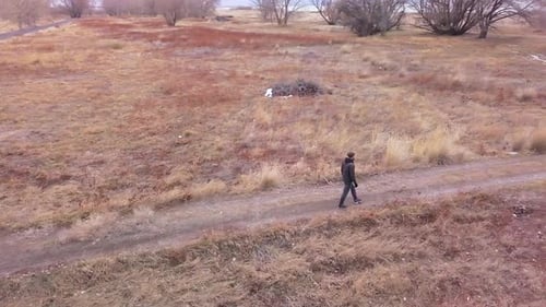 Athletic man walking along a path in the winter landscape