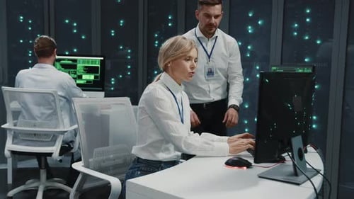 Couple of Caucasian Male Female IT Specialists Operating in Server Room IT Administrator with Office