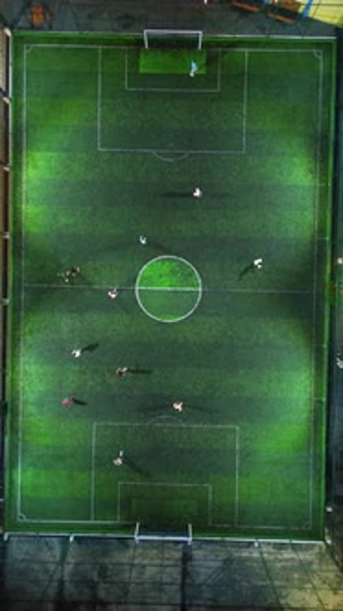 Vertical Drone Footage of mini football match, soccer. MiniFootball field and Footballers from drone