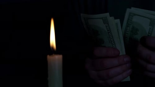 Hands Count Money by Candle Light