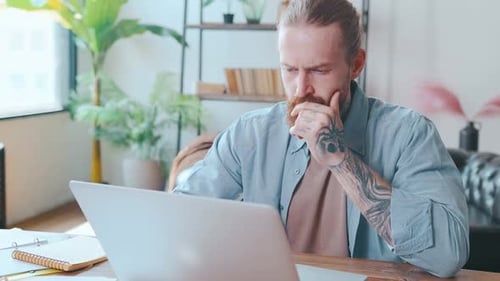Man Working at Laptop in Home Office