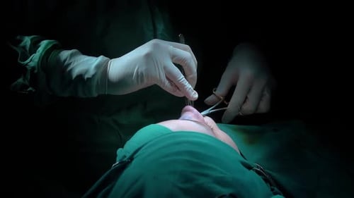 Rhinoplasty procedure and stitching doctor, end of operation.. Rhinoplasty procedure performed by a