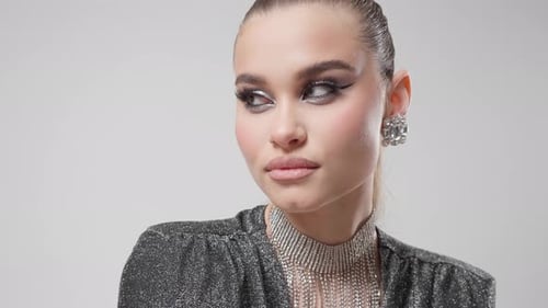 Elegant Woman with Glamorous Makeup and Jewelry Posing