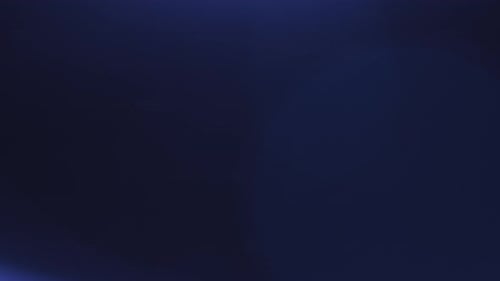 Abstract Overlay with Blue Light Transition Around Frame Blurred Lens Flare on Dark Background