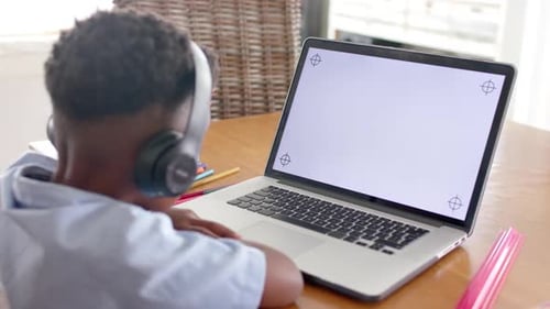 Young Boy Learning at Home with Laptop