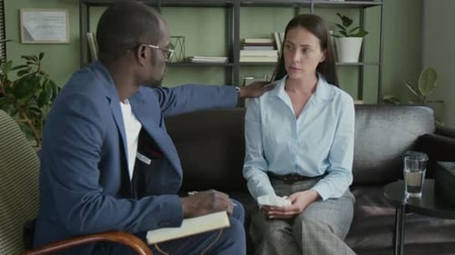 Male Counsellor Touching Shoulder of Frustrated Female Client