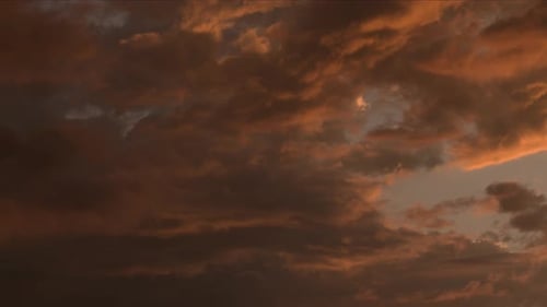Moody Clouds Floating in an Orange Sky