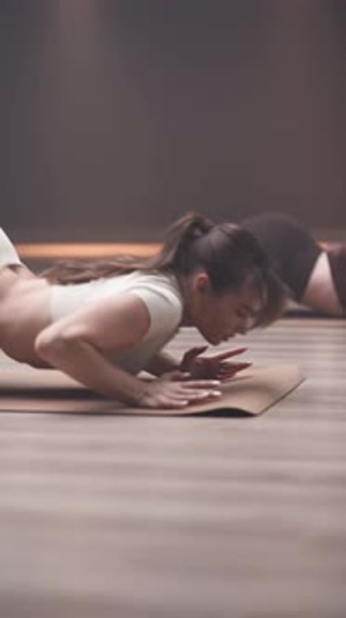 Women Practicing Yoga Poses in Studio