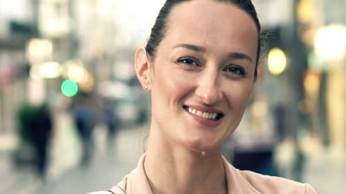 Portrait of Happy, Pretty Woman in City 30s