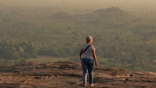 Mature Woman Exploring, Walking on Hill 30s