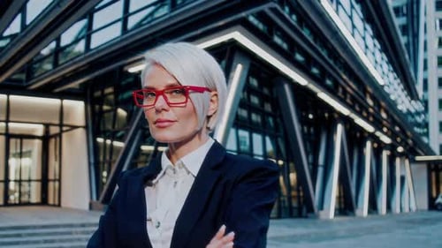 Confident Woman with Red Glasses in City