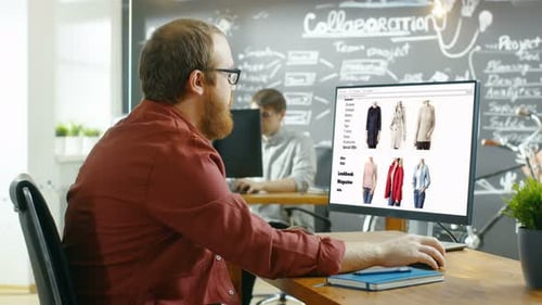 Web Designer Works on a Website for Online Retail Clothing Shop. He and Colleagues Work in Styish C