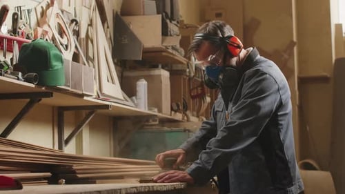 Carpenter Polishing Wood in Workshop
