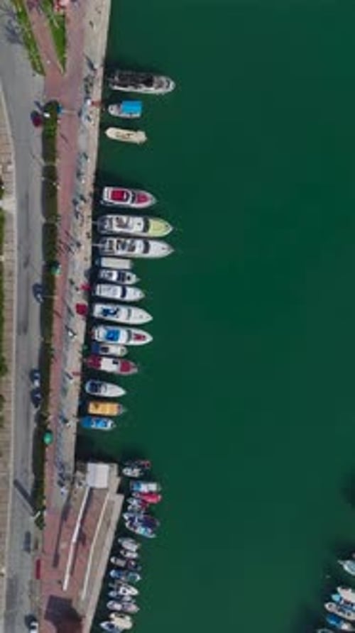 Vertical Video of a Luxurious Port With Private Yachts Captured From a Drone With an Upscale Seaside