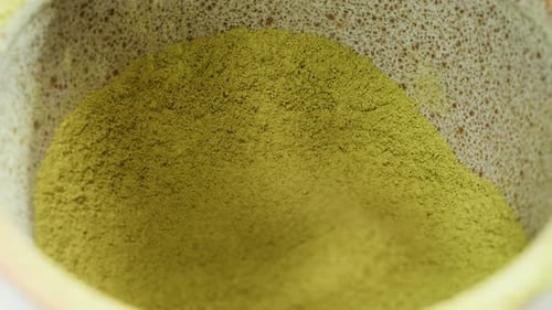 Matcha Green Tea Cooking Process Japanese Powder Green Tea in a Bowl with Bamboo Whisk Macro Close