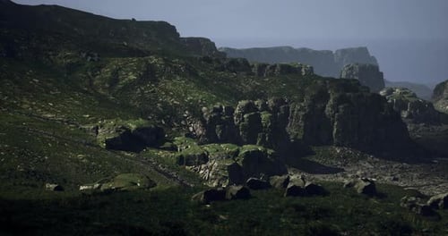 Mountain Landscape with Rocky Formations and Distant Ocean View Near Sunset