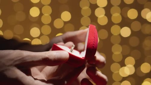 Close Up of Hands Opening Ring Box