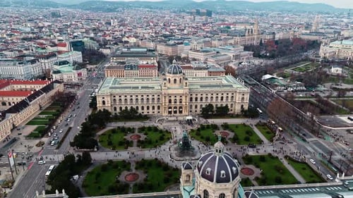 aerial drone shot panning left of Austrian natural history museum in Vienna in winter sunlight