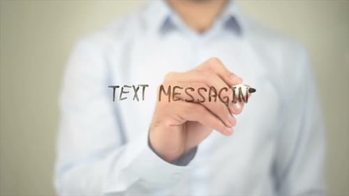 Man Writes Text Messaging on Clear Surface