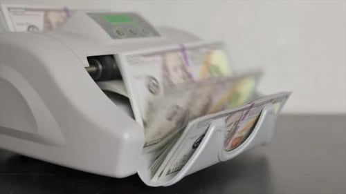 Machine is Counting Money in Office