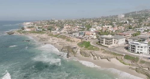 a beach with buildings and a body of water